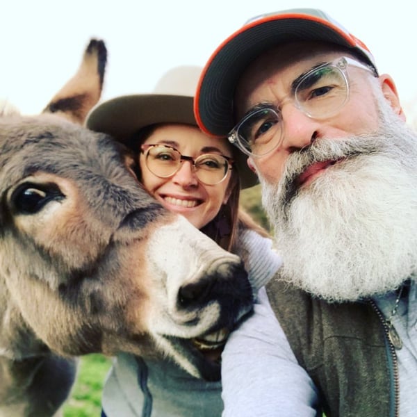 Happy man, woman, and donkey