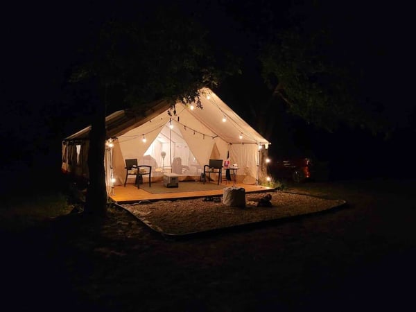 Tent exterior at night looking cozy