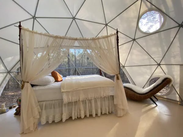 Luxurious bed with curtains in dome