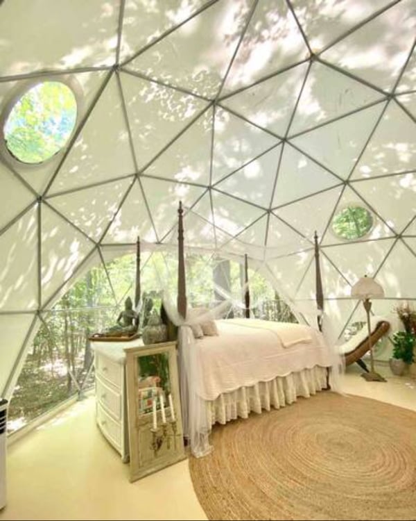 Bed with tall bedposts inside dome