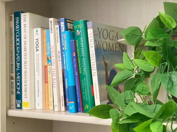 Books on shelf with plants