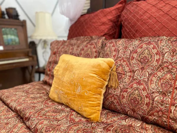 Golden pillow on bedspread