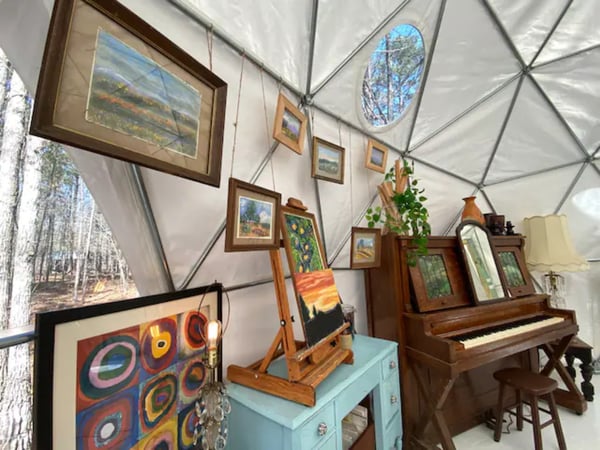 furniture, a piano, and wall art inside dome
