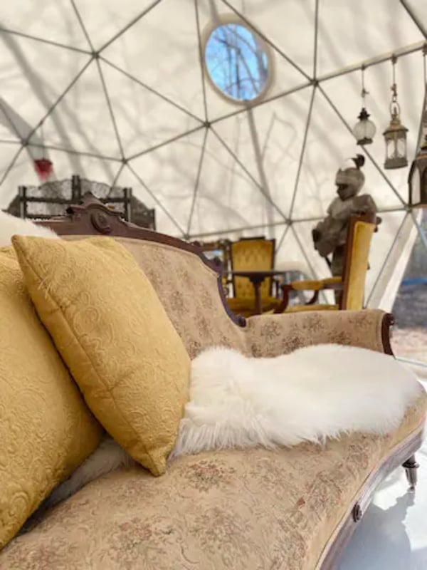 Couch with throw and pillow inside dome