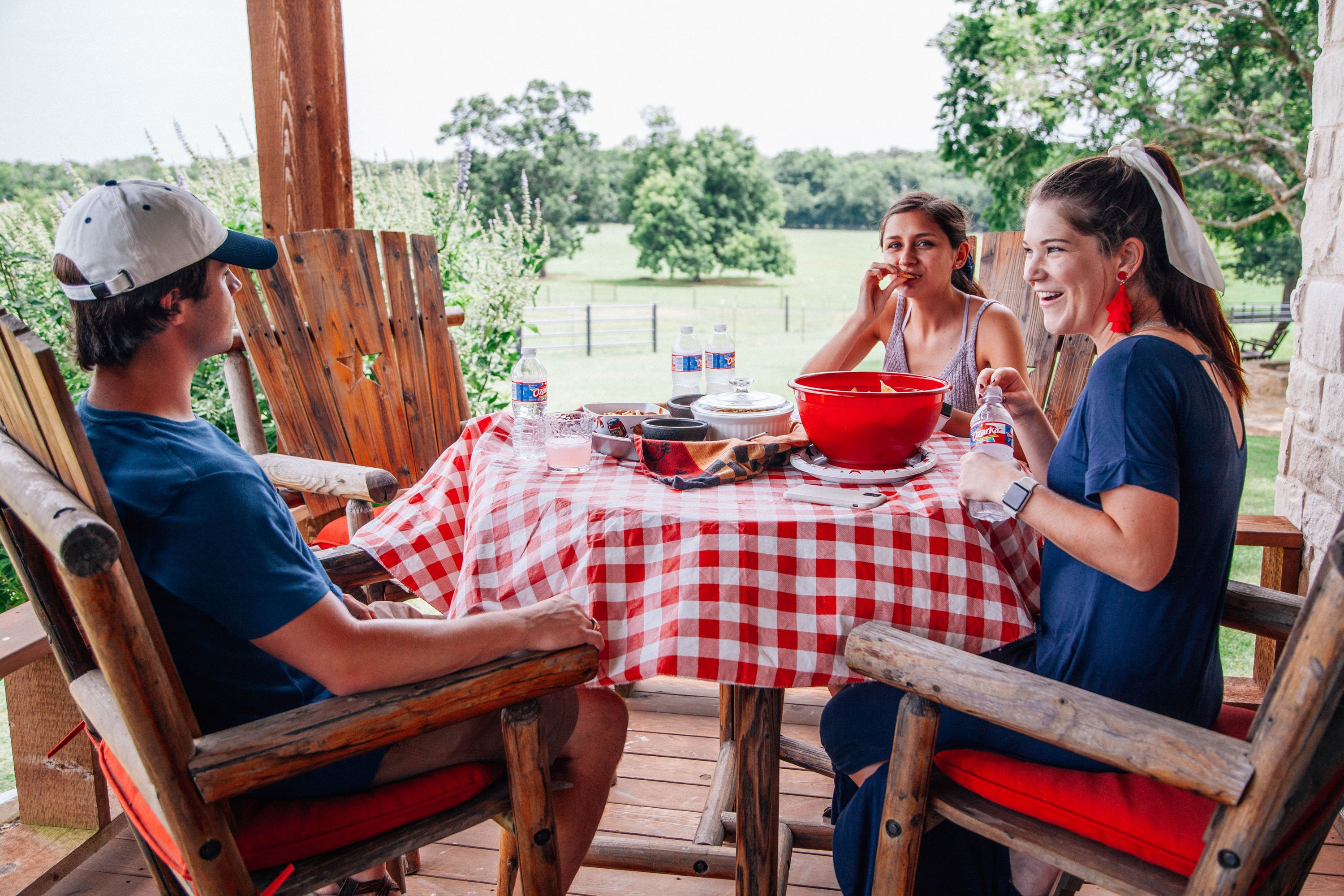 Group of people eating at outdoors picnic table