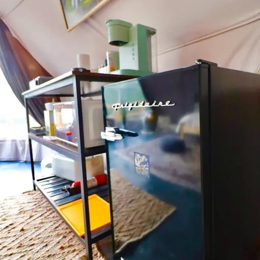 Mini fridge and basic kitchen essentials for a glamping trip in Texas