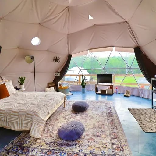 Beautiful interior of glamping dome with views of farm