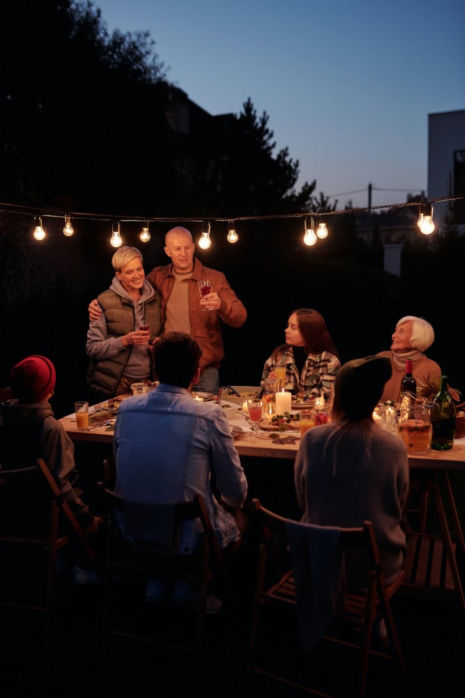 group around table outdoors at twilight